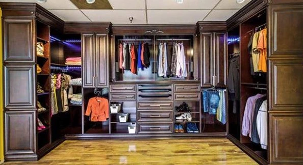 Big closet remodel with brown newport styled cabinets