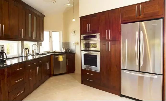 Brown custom cabinets with silver kitchen applicances in Fayetteville NC