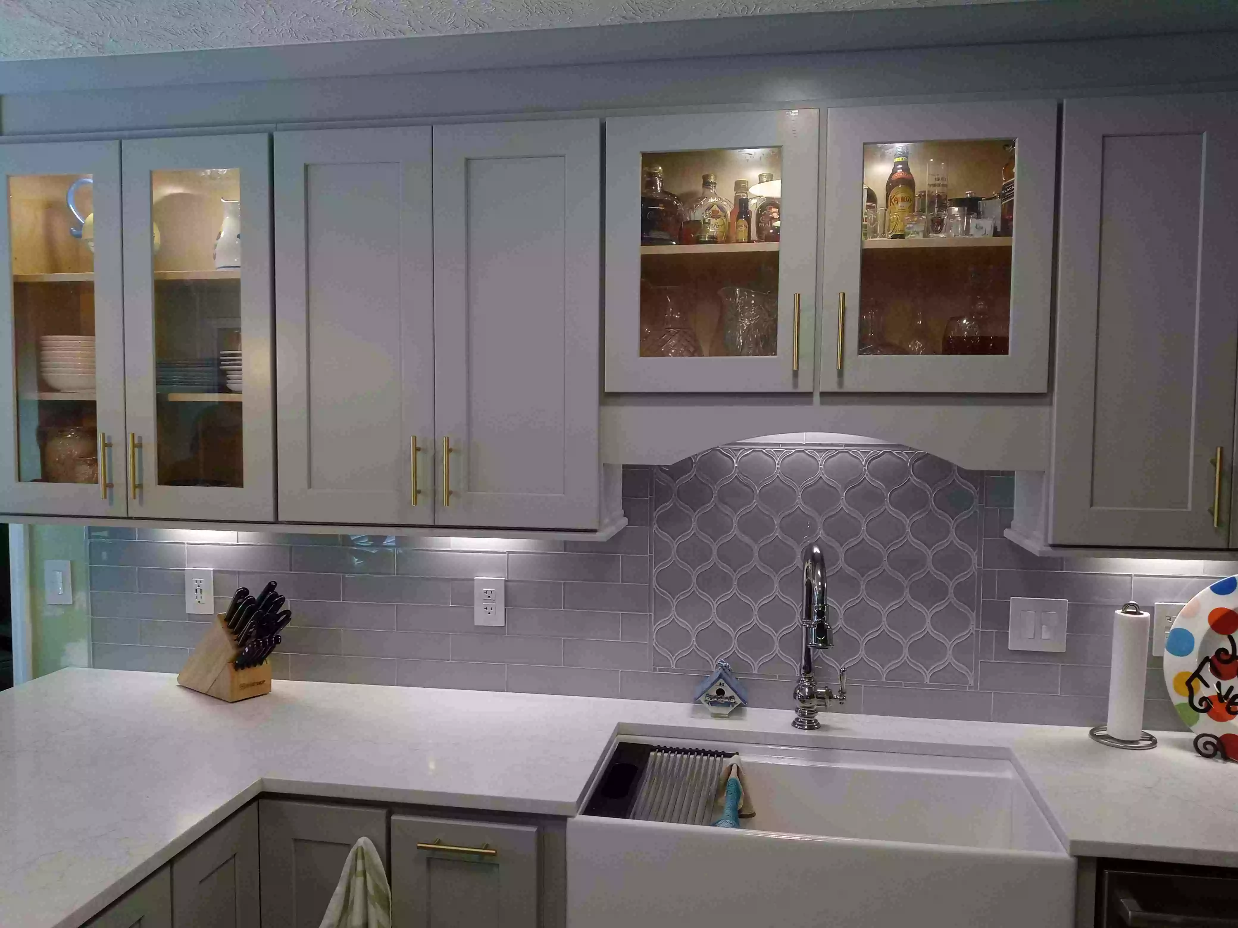 Kitchen cabinet project with beautiful white sink and white countertop.