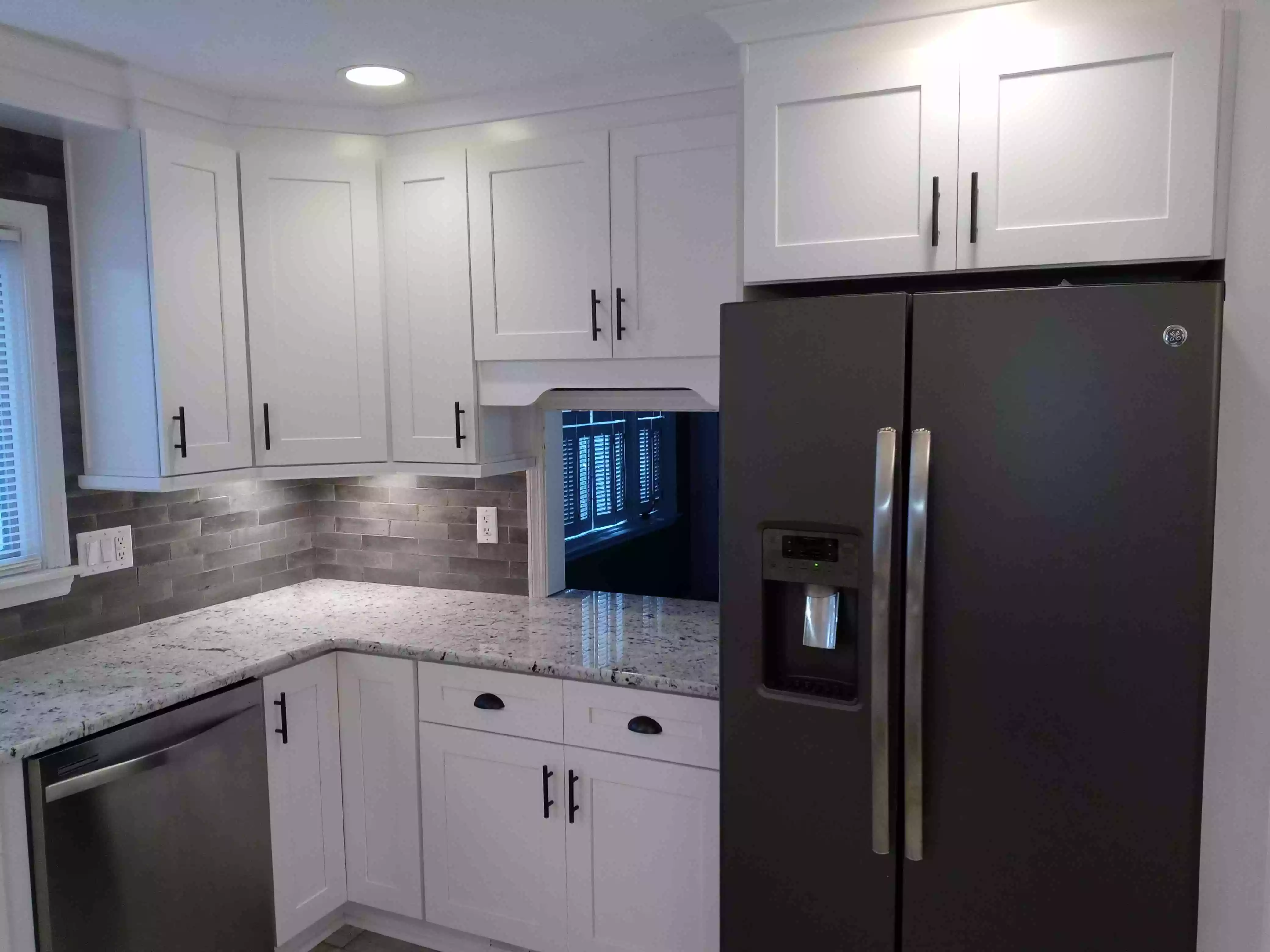 Dove white shaker custom cabinets with silver appliances