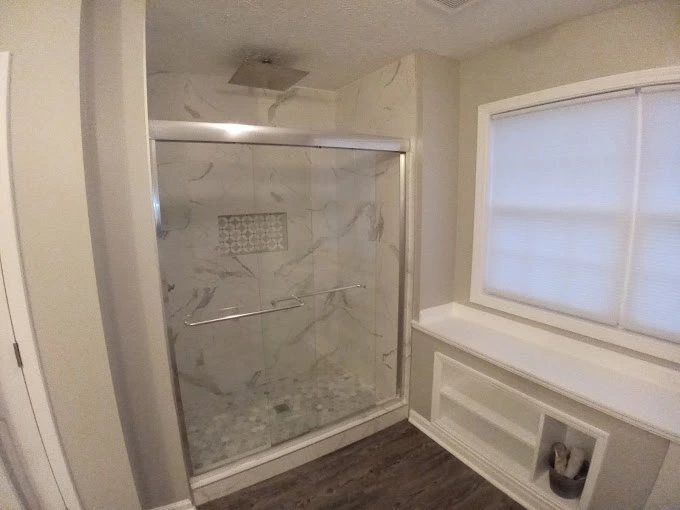Custom shower remodel with tile walls and glass door