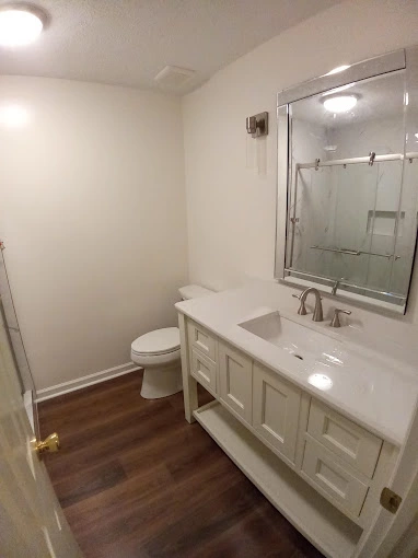 Cheap and budget friendly bathroom remodel with white walls and white cabinets and sinks