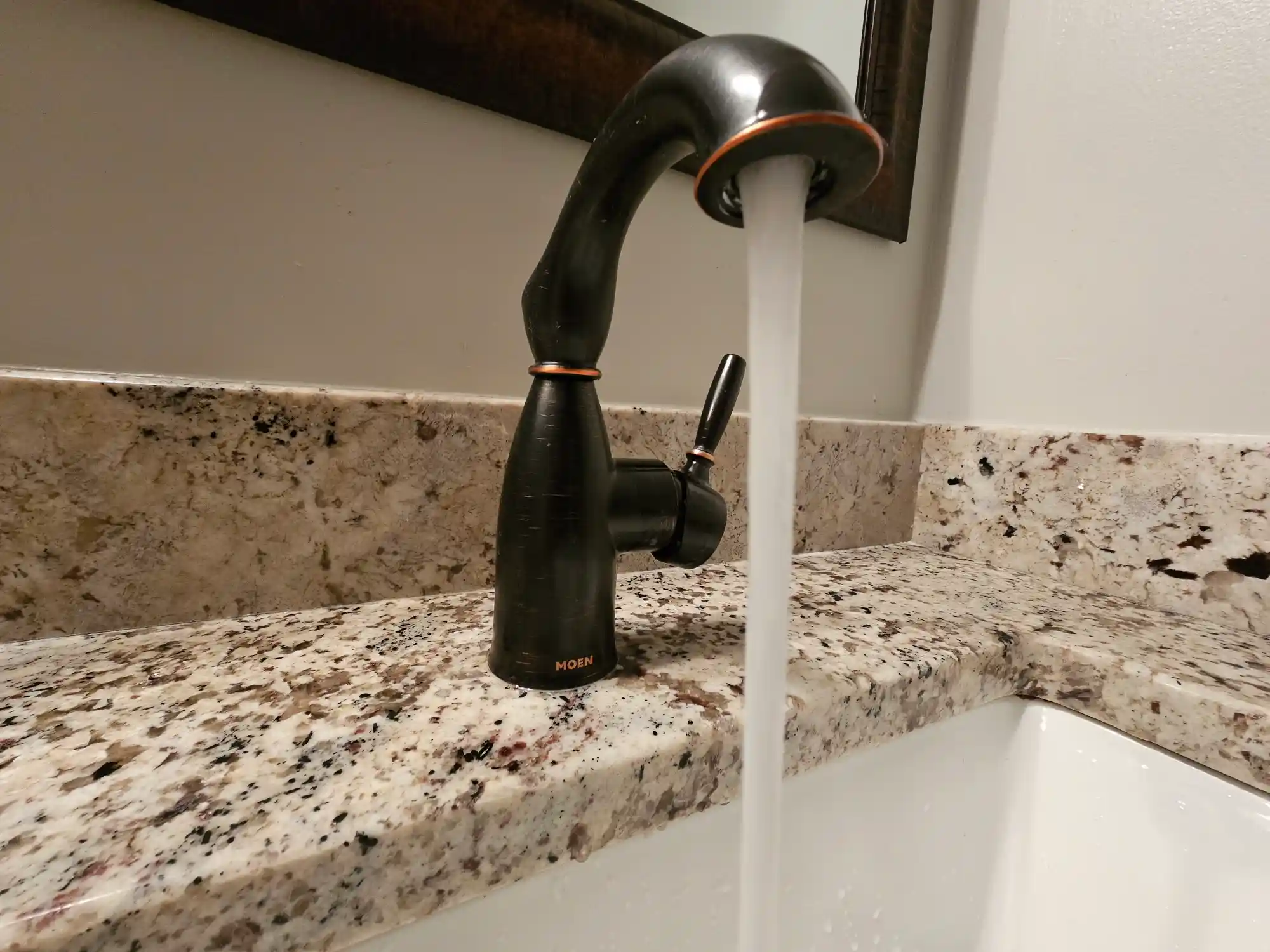 Bathroom faucet with running water.