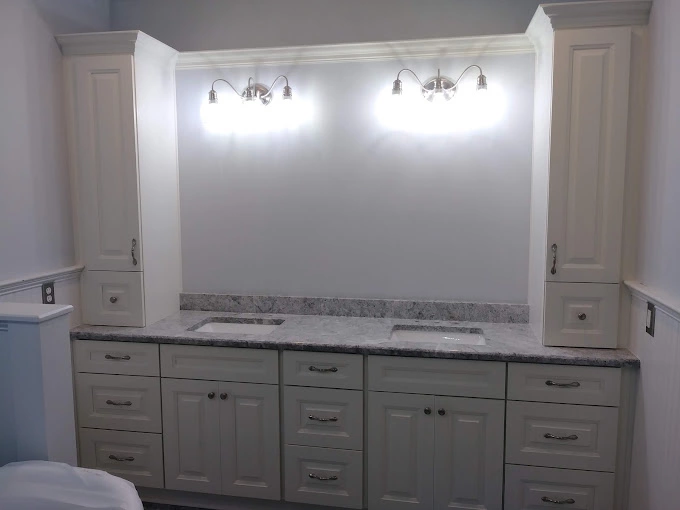 Elegant white bathroom cabinets with dual sinks and custom light fixtures