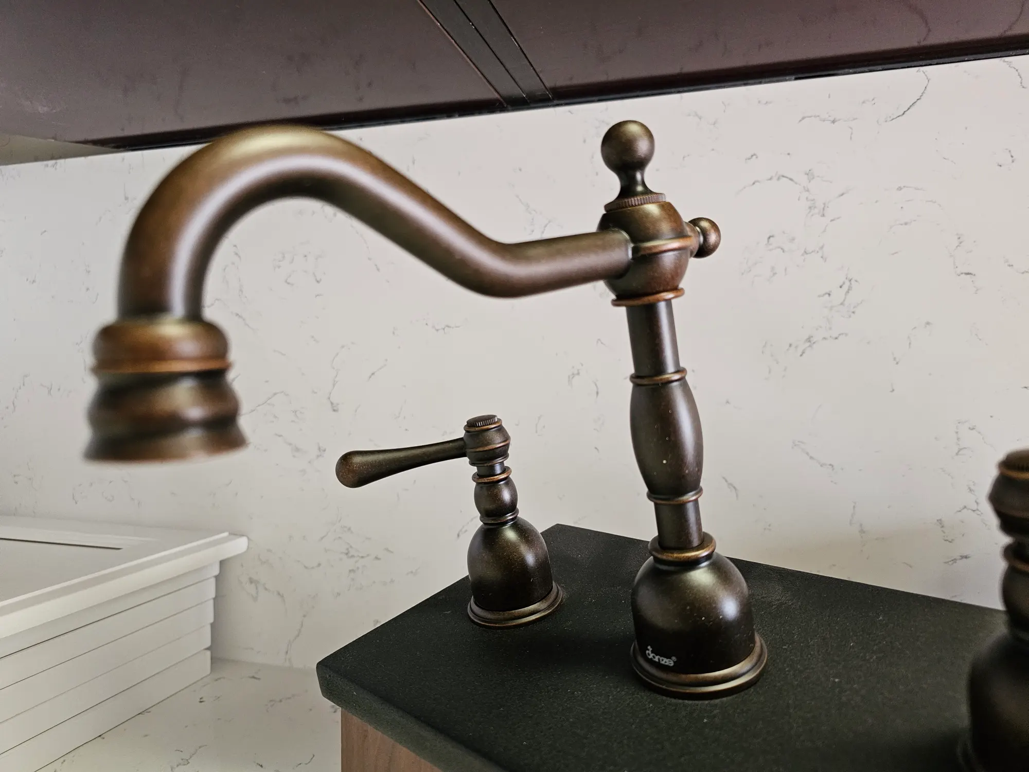 Up close photo of bronze sink set.