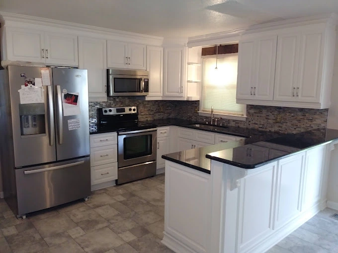 White kitchen cabinets and silver kitchen applicances for kitchen remodel near Aberdeen NC