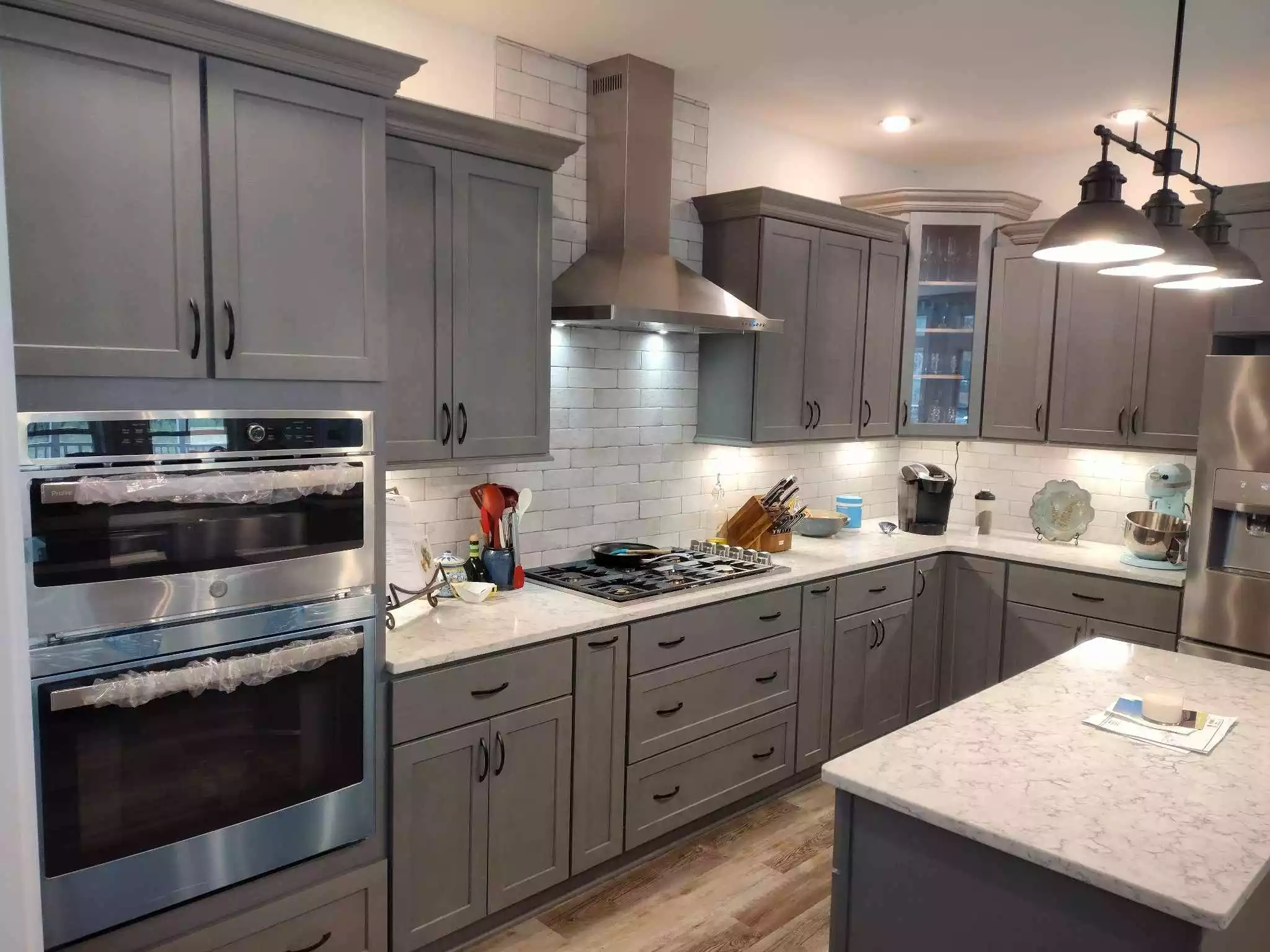 Beautiful custom kitchen remodeling project with smoky blue cabinets and custom light fixtures