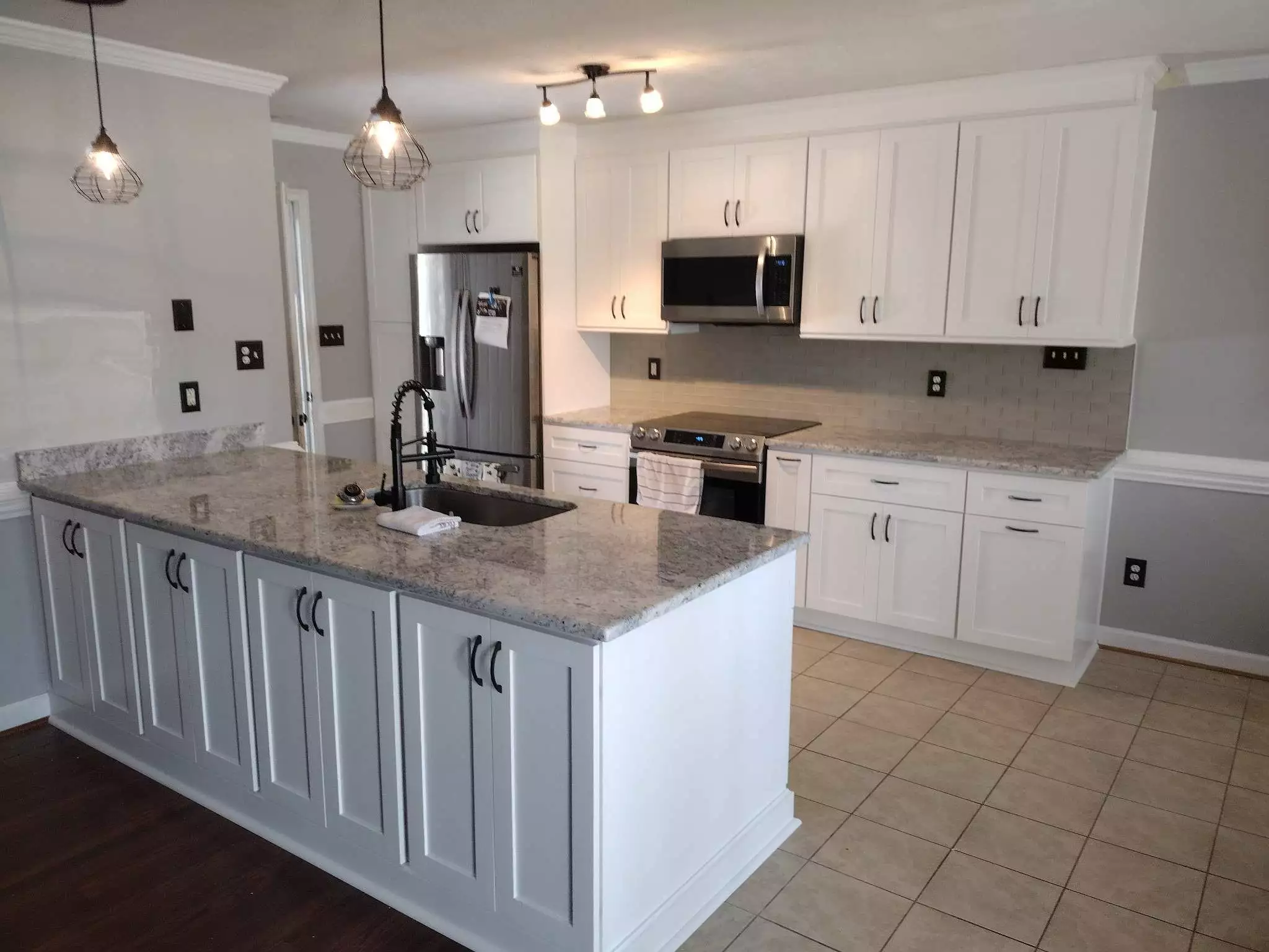 White kitchen design with black cabinet handles in Fayetteville NC