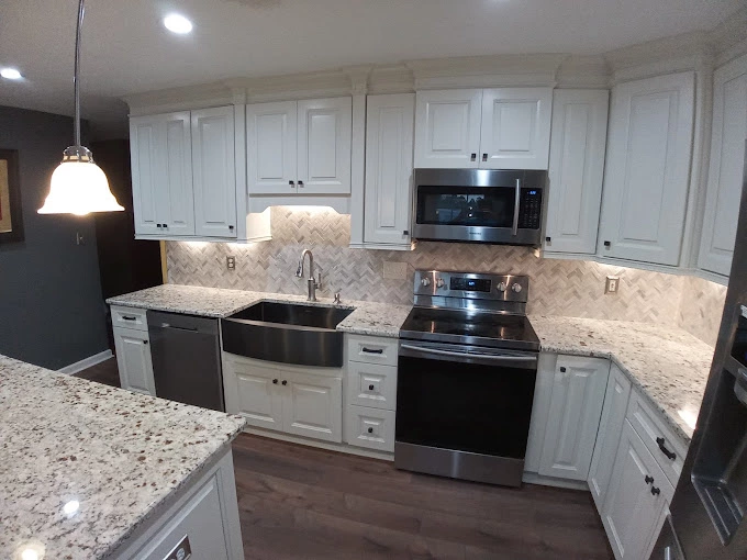 White custom kitchen cabinets with beautiful wood flooring