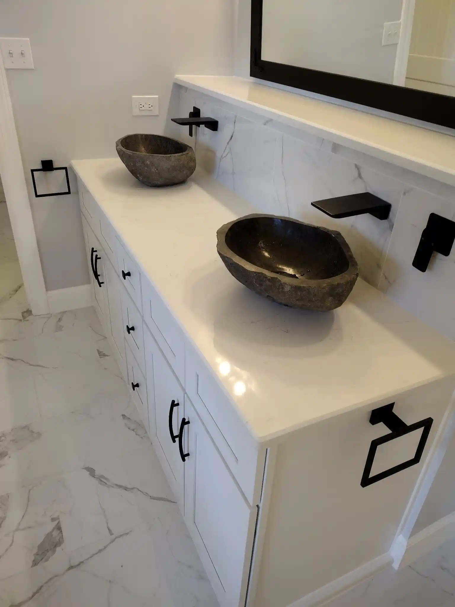 Bathroom renovation project with custom sinks.