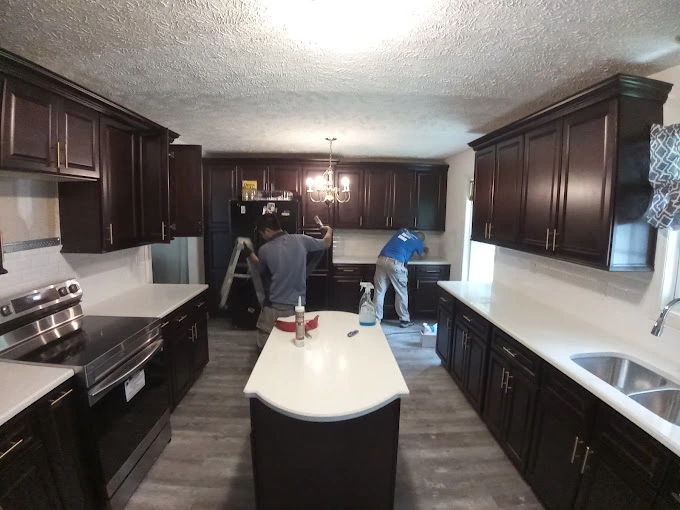 Team members of J&J Kitchen Cabinets working on kitchen remodeling project.